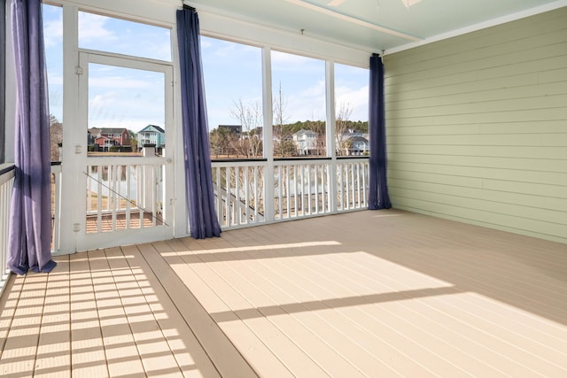 unfurnished sunroom featuring a residential view