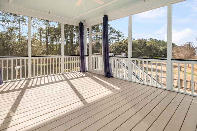 unfurnished sunroom featuring a wealth of natural light and ceiling fan