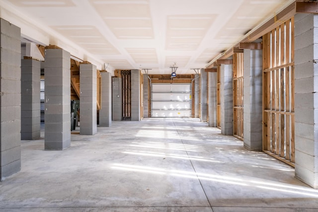 hall with unfinished concrete floors and concrete block wall