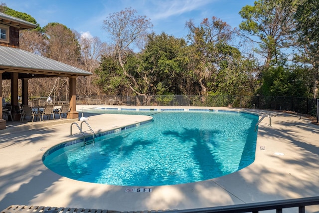 pool featuring a gazebo, fence, and a patio area