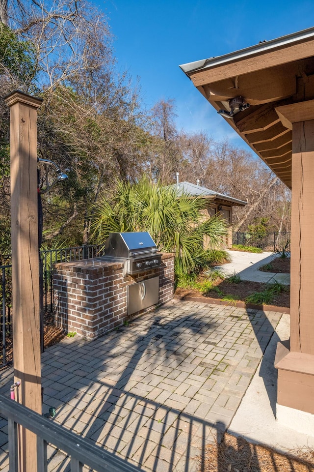 view of patio featuring exterior kitchen and grilling area