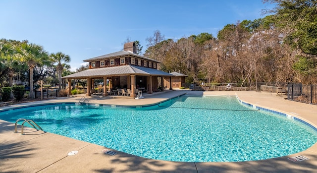 pool featuring a gazebo, fence, and a patio area