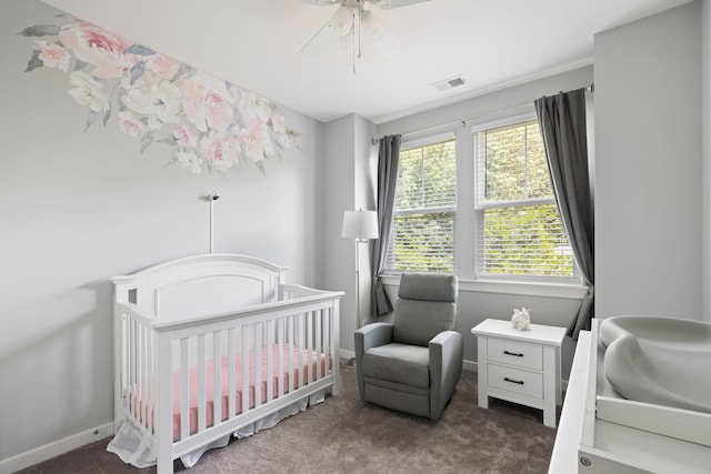 bedroom with carpet flooring, baseboards, a ceiling fan, and a nursery area