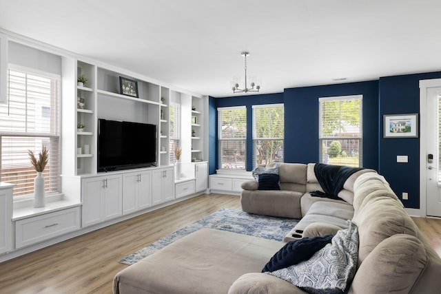 living room featuring a chandelier and light wood-style flooring