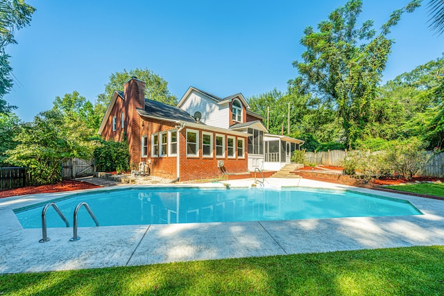 view of pool featuring a sunroom