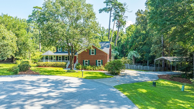 view of front of house featuring a front lawn and a carport