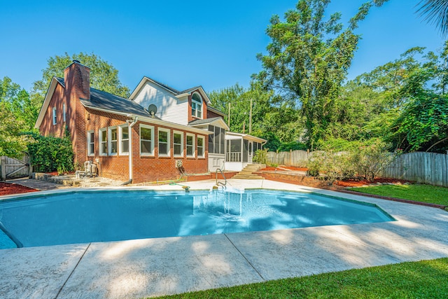 view of swimming pool with a sunroom