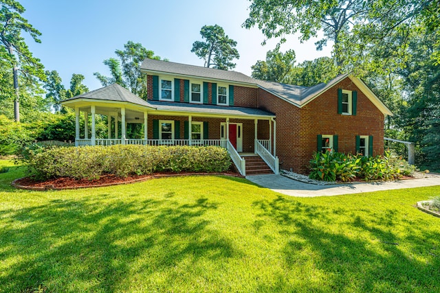 view of front of home with covered porch and a front yard