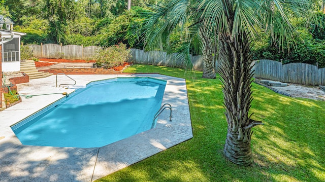 view of swimming pool with a patio and a yard