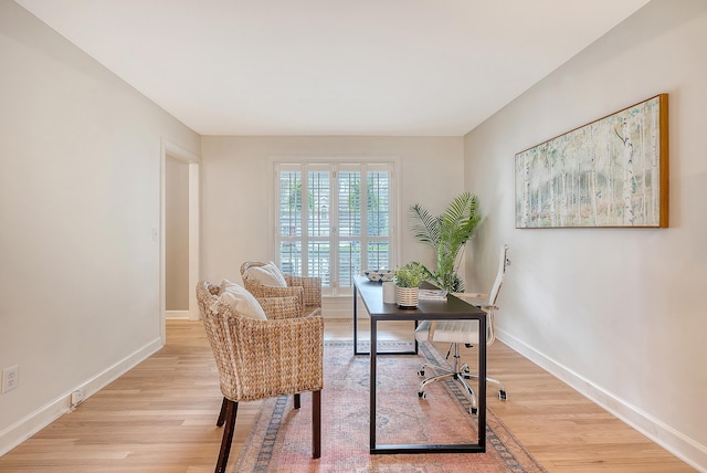 home office with baseboards and light wood-style floors