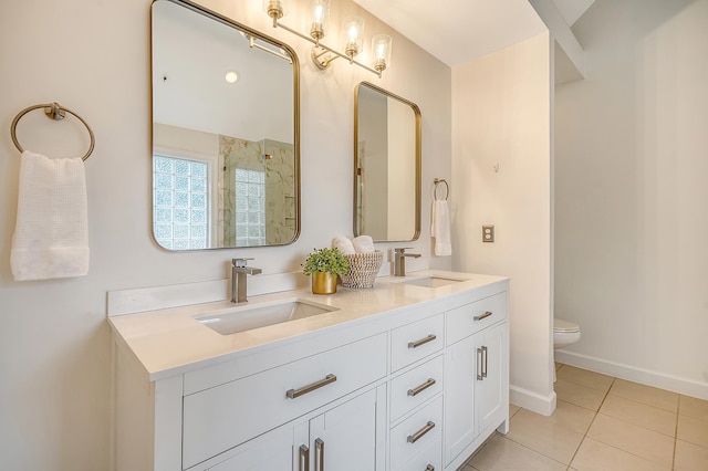 bathroom featuring tile patterned flooring, a sink, toilet, and baseboards