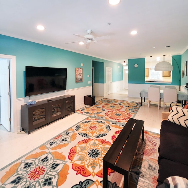 living room featuring crown molding and ceiling fan