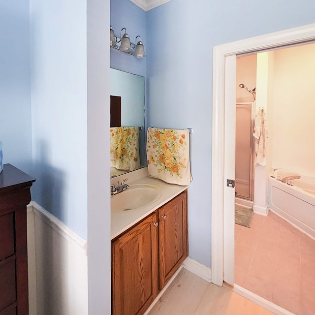 bathroom with tile patterned flooring, vanity, and shower with separate bathtub