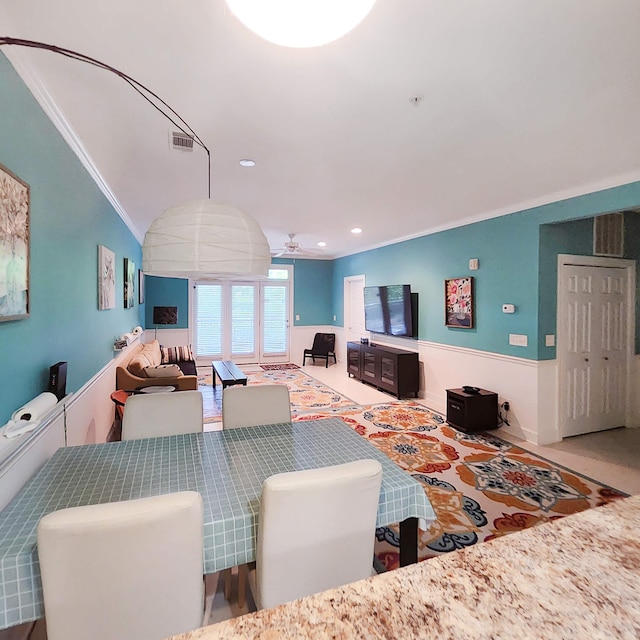 dining space with carpet flooring, ceiling fan, lofted ceiling, and ornamental molding