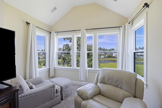 living area featuring vaulted ceiling and carpet flooring