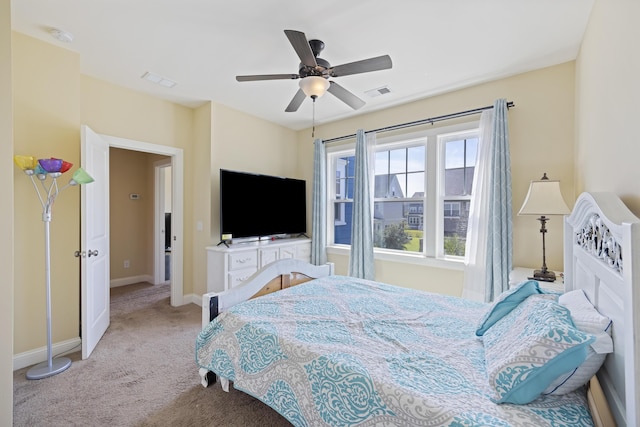 bedroom with ceiling fan and light colored carpet