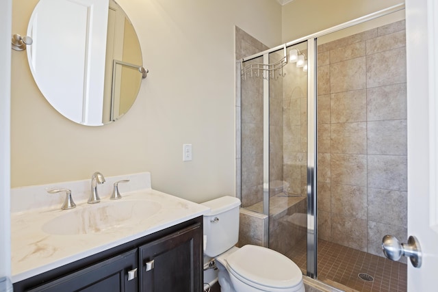 bathroom with toilet, a shower with shower door, and vanity