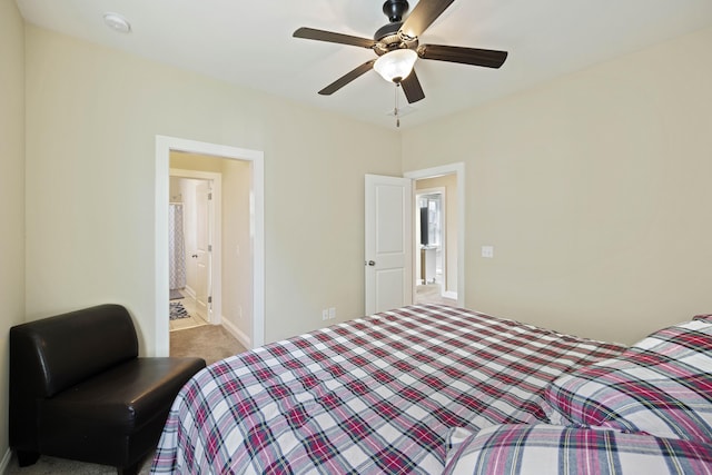 carpeted bedroom with ceiling fan and connected bathroom