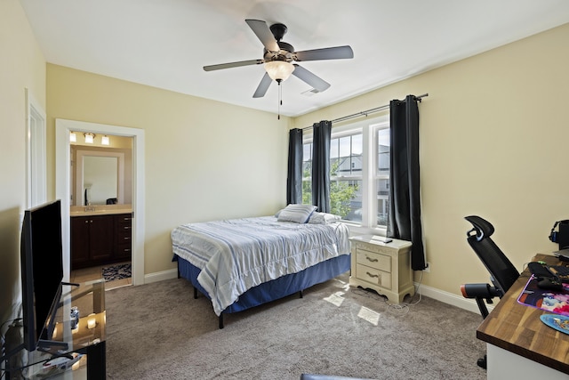 carpeted bedroom with ceiling fan and connected bathroom