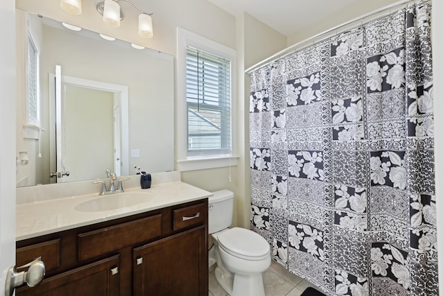 bathroom with toilet, tile patterned flooring, and vanity