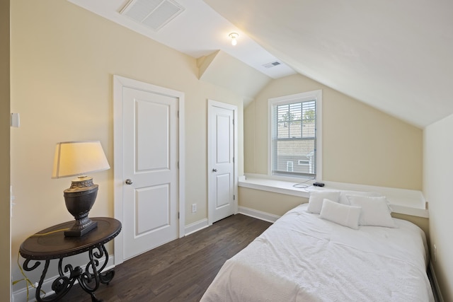 bedroom featuring lofted ceiling and dark hardwood / wood-style flooring