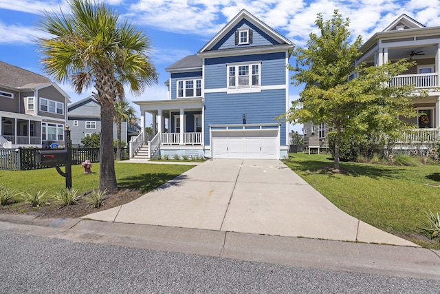 view of front of home with a garage, a front lawn, and covered porch