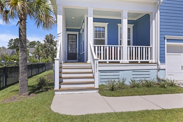 property entrance featuring a porch and a lawn