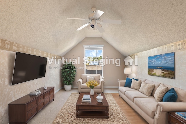 carpeted living room with lofted ceiling, a textured ceiling, and ceiling fan