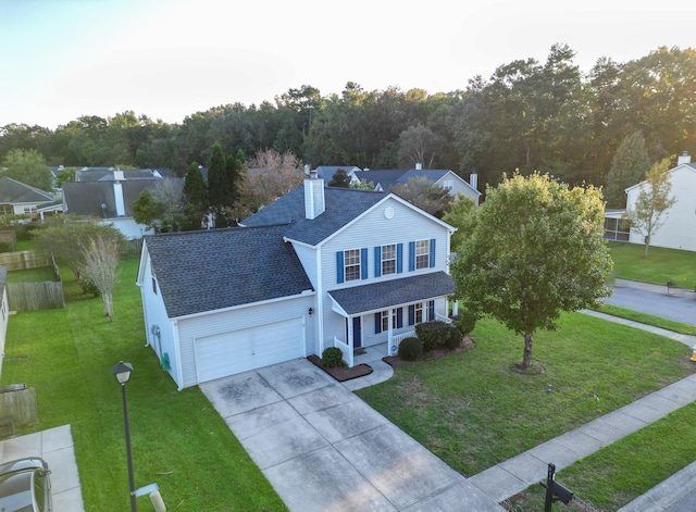 view of front of property with a garage and a front lawn