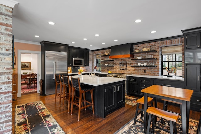 2 Bedons Aly, Charleston, SC 29401 - kitchen with open shelves, wall chimney exhaust hood, dark cabinets, crown molding, and stainless steel appliances