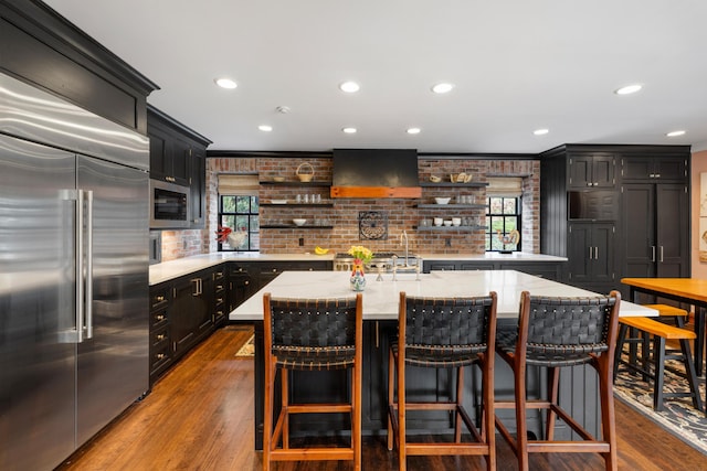 2 Bedons Aly, Charleston, SC 29401 - kitchen featuring built in appliances, wall chimney range hood, open shelves, and a wealth of natural light