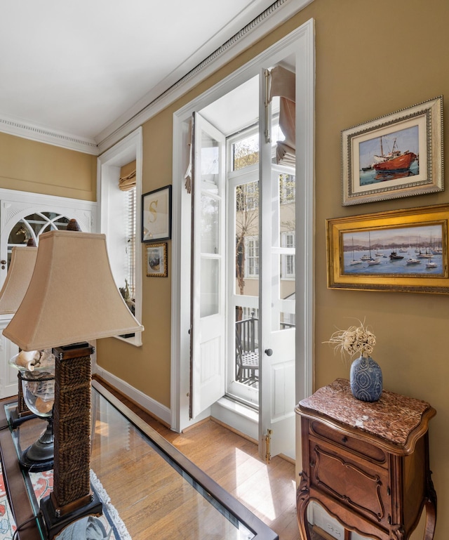 2 Bedons Aly, Charleston, SC 29401 - doorway to outside featuring light wood finished floors, baseboards, and ornamental molding