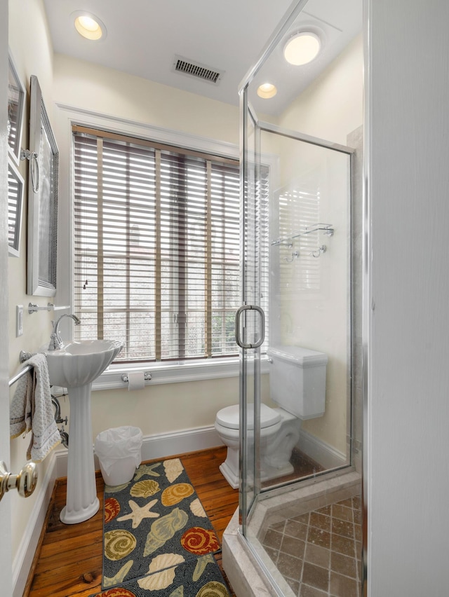 2 Bedons Aly, Charleston, SC 29401 - bathroom featuring baseboards, toilet, a shower stall, visible vents, and wood finished floors
