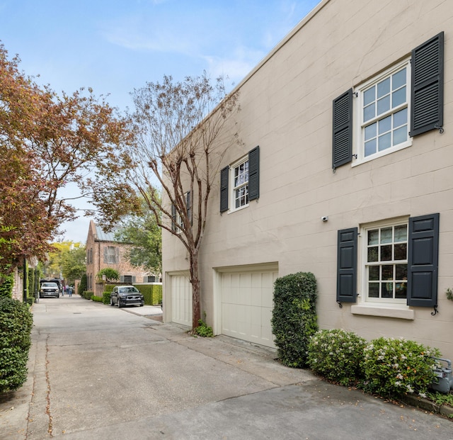 2 Bedons Aly, Charleston, SC 29401 - view of side of home featuring a garage and driveway