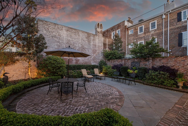 2 Bedons Aly, Charleston, SC 29401 - patio terrace at dusk featuring outdoor dining space