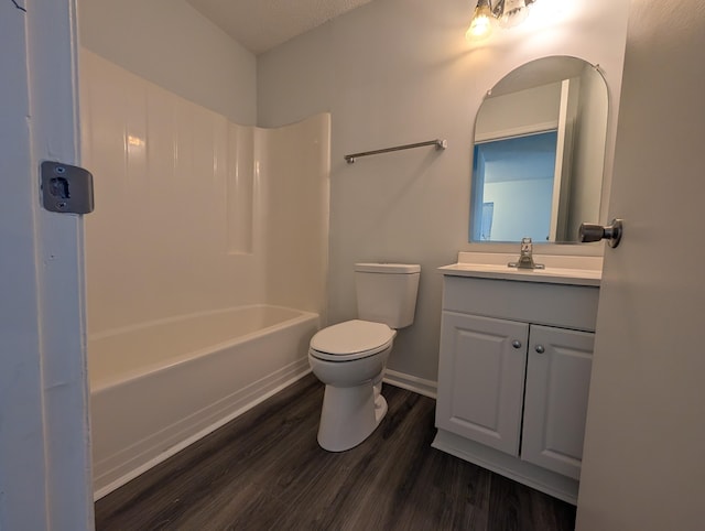 full bathroom featuring hardwood / wood-style flooring, vanity, toilet, and tub / shower combination