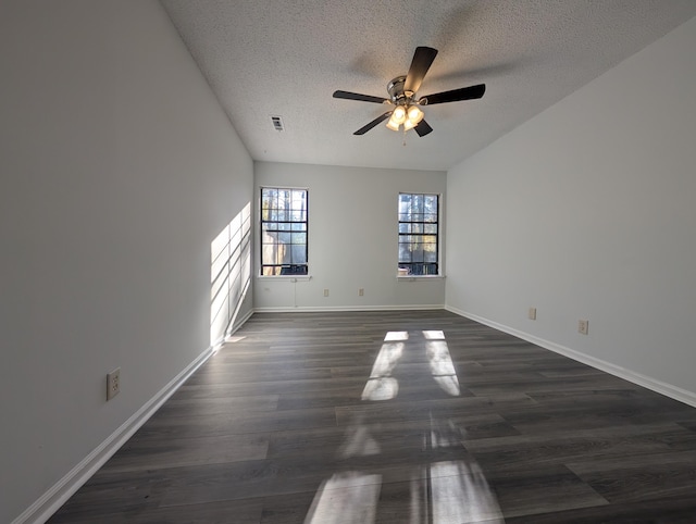 unfurnished room with ceiling fan, dark hardwood / wood-style flooring, and a textured ceiling