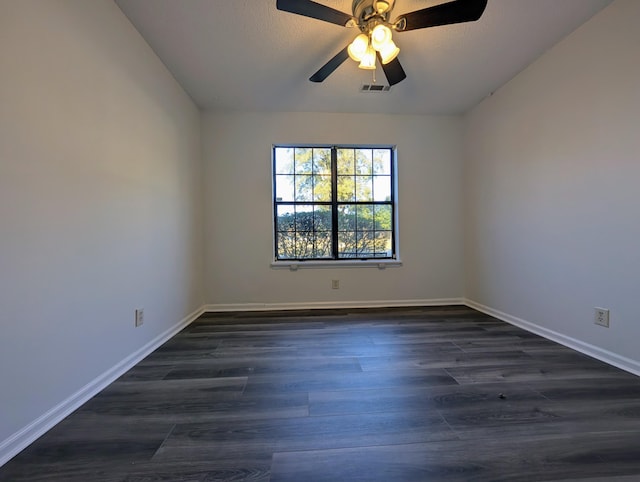 spare room with dark hardwood / wood-style floors and ceiling fan