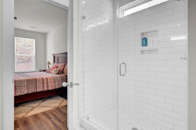 full bath featuring a shower stall, wood finished floors, and connected bathroom