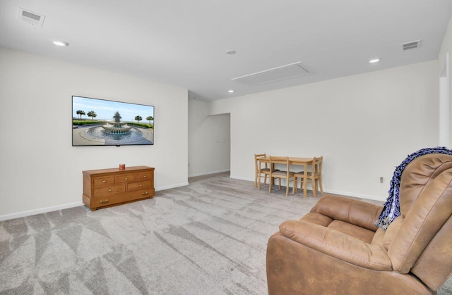 sitting room with visible vents, baseboards, and carpet flooring