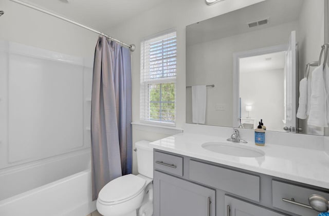 full bathroom featuring vanity, shower / bath combination with curtain, toilet, and visible vents