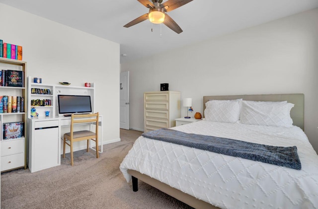 carpeted bedroom with a ceiling fan and baseboards