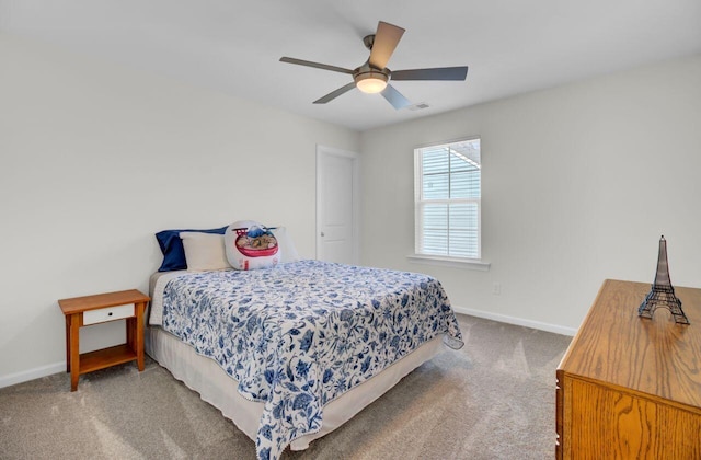 carpeted bedroom with visible vents, a ceiling fan, and baseboards