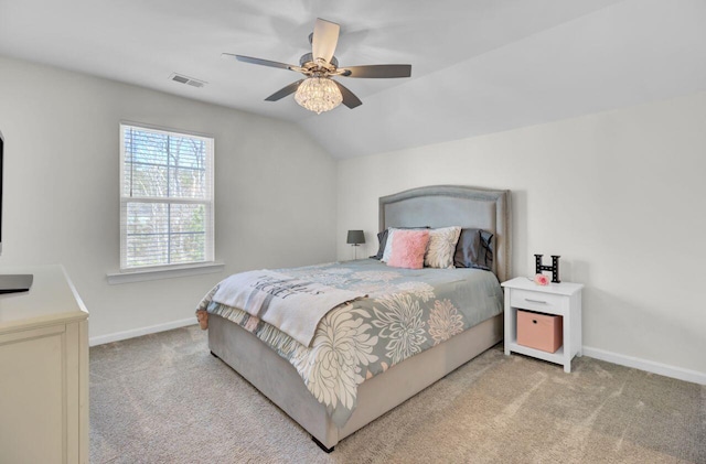 bedroom featuring visible vents, light colored carpet, baseboards, and vaulted ceiling