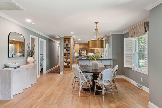 dining space with visible vents, baseboards, and light wood-style floors