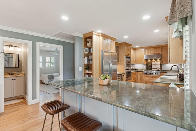 kitchen featuring appliances with stainless steel finishes, open shelves, a sink, ornamental molding, and under cabinet range hood