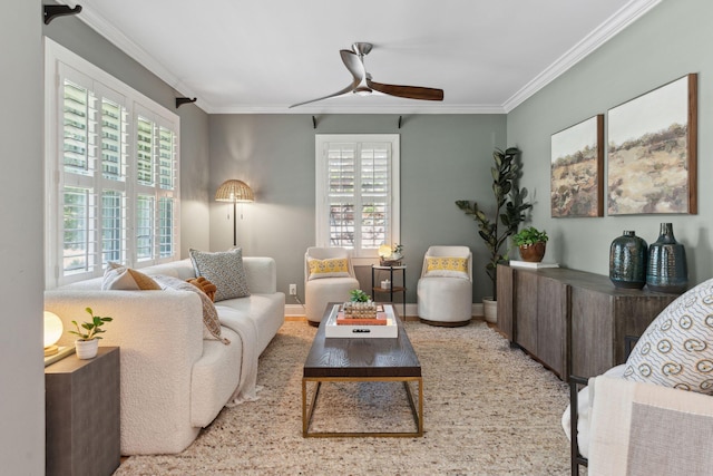 living area with crown molding, ceiling fan, plenty of natural light, and baseboards