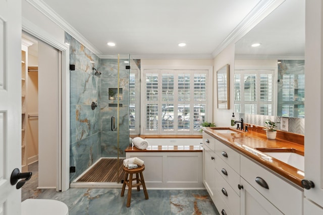 full bath featuring crown molding, a shower stall, a sink, and a bath