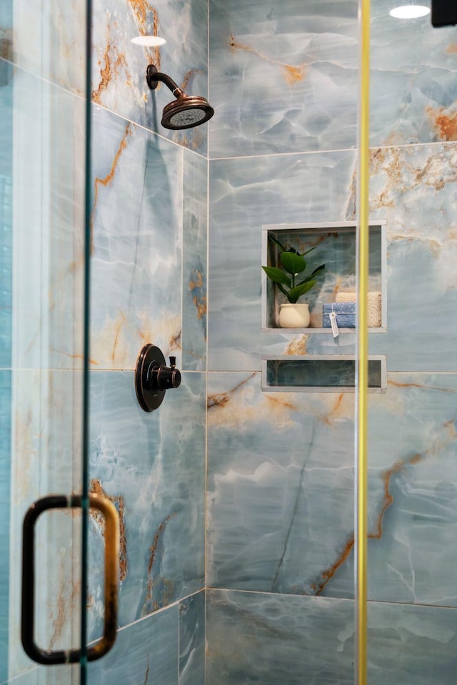 full bath with a marble finish shower