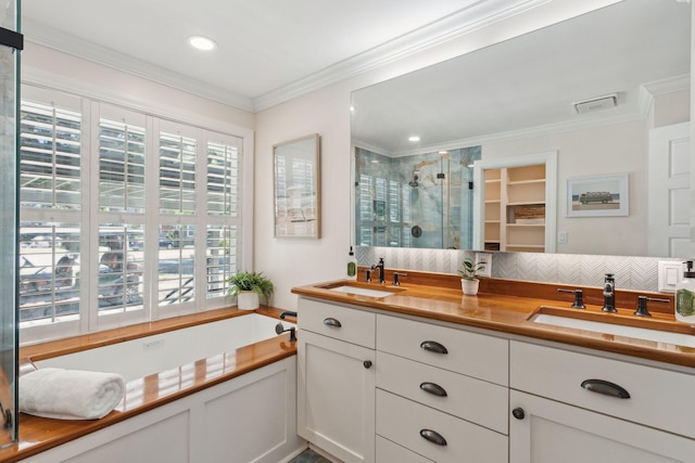 bathroom featuring visible vents, a shower stall, a sink, and a garden tub